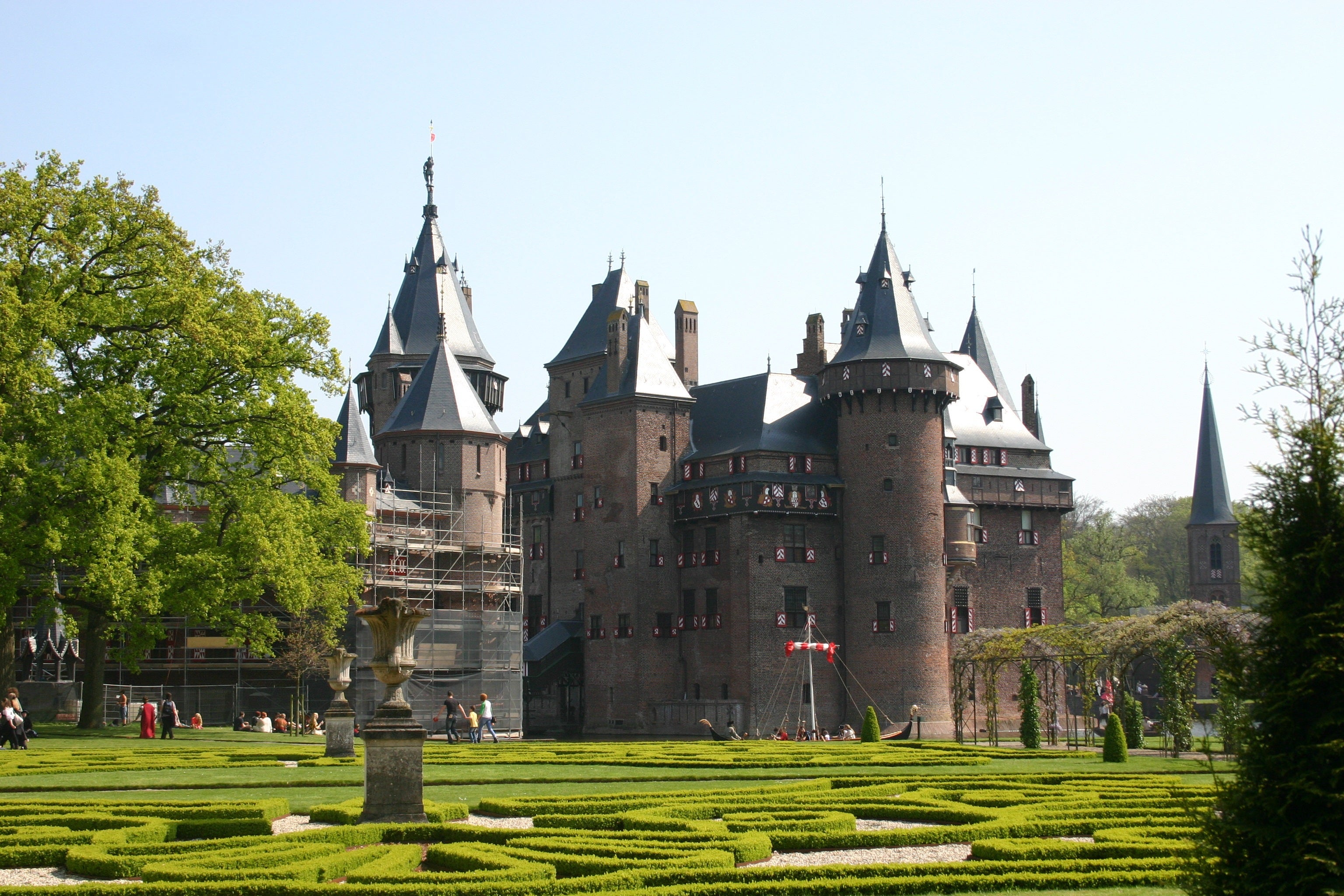Historic castle with intricate architecture and gardens on a clear day